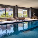 Espace bien-&ecirc;tre couvert et chauff&eacute; avec piscine, spa, et chaises longues